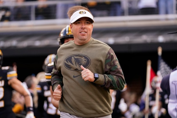 Missouri head coach Eliah Drinkwitz jogs out to the field prior to the Tigers' 36-7 rout of Tennessee Nov. 11, 2023, in Columbia. (AP Photo/Jeff Roberson)