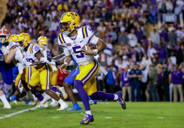 LSU quarterback Jayden Daniels (5) runs for a touchdown against Florida during the Gators' 52-25 loss Nov. 11 in Baton Rouge, La. (AP Photo/Derick Hingle)