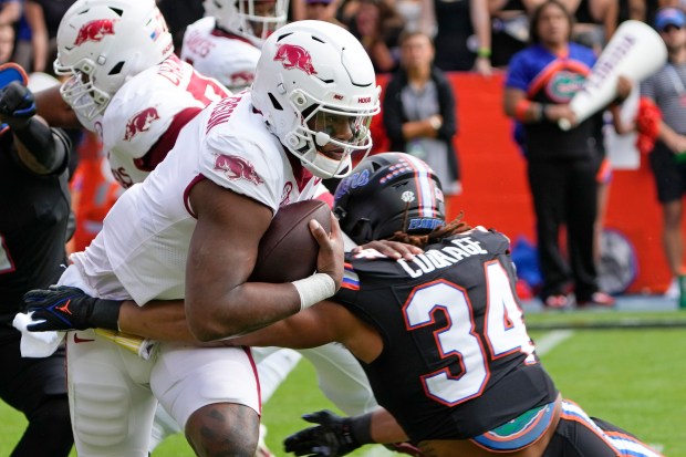 Florida linebacker Mannie Nunnery (34) stops Arkansas quarterback KJ Jefferson as he tries to scramble from the pocket during the Gators' 39-36 overtime loss to the Razorbacks Nov. 4 in Gainesville. (AP Photo/John Raoux)