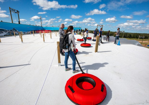 Visitors get ready to slide down the snowy slopes at Snowcat Ridge, Florida's first snow park, near Dade City on Friday, Nov. 20, 2020.